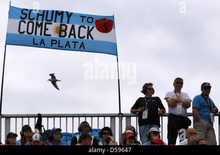 Motor racing fans stand next to a transparent for Germany's Formula One driver Michael Schumacher of Mercedes GP in the stands during the qualification race on race track ''Gille Villeneuve'' in Montreal, Canada, 12 June 2010. Photo: Jens Buettner Stock Photo