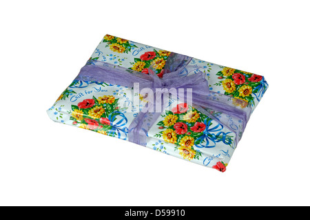 Present wrapped in floral paper with lilac coloured ribbon on a white background. Stock Photo