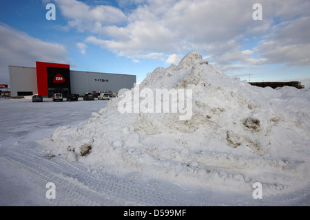 cleared snow piled up in the car park of a supermarket kirkenes finnmark norway europe Stock Photo
