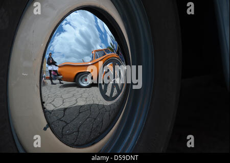 The reflection of an orange NSU TTS in a chrome-plated hub cap during Southern Germany's biggest classic car meeting in Kulmbach, Germany on 20 June 2010. The meeting took place for the 14th time. Over the weekend, roundabout 500 vehicles were shown during the fair. Photo: David Ebener    In der Chromradkappe eines VW Käfer spiegelt sich am Sonntag (20.06.2010) auf dem Oldtimer-Tre Stock Photo