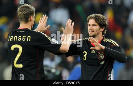 Germany's Marcell Jansen and Arne Friedrich celebrate after the 2010 FIFA World Cup group D match between Ghana and Germany at Soccer City, Johannesburg, South Africa 23 June 2010. Photo: Marcus Brandt dpa - Please refer to http://dpaq.de/FIFA-WM2010-TC Stock Photo