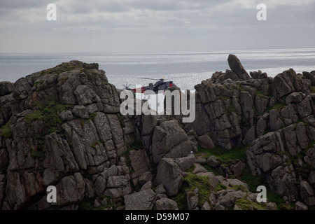 RAF Air Sea Rescue Sea King helicopter in action at Logan Rock, Penzance, Cornwall, UK Stock Photo