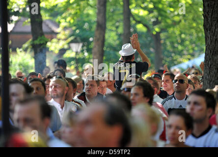 Fans of the German soccer team watch the World Cub quarterfinal-game Germany against Argentina in a public viewing area in a biergarden in Munich (Upper Bavaria). Germany wins 4:0. Photo: Andreas Gebert dpa/Iby Stock Photo