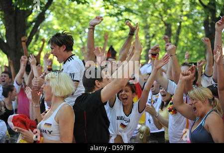 Fans of the German soccer team cheer after the World Cub quarterfinal-game Germany against Argentina in a public viewing area within a biergarden in Munich (Upper Bavaria), Germany, 03 July 2010. Germany wins 4:0. Photo: Andreas Gebert dpa/Iby Stock Photo
