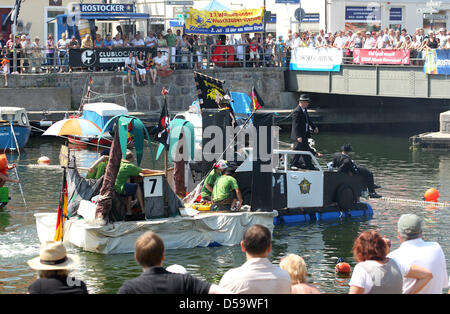 At the 23rd installment of the washtub race on the Alte Strom ('old stream'), spectators enjoy the imaginatively designed naval vehicles at the Baltic Sea bath Warnemuende in Rostock, Germany, 03 July 2010. Ten teams participated in the traditional spectacle at the start of the Warnemuende Week. Photo: Bernd Wuestneck Stock Photo