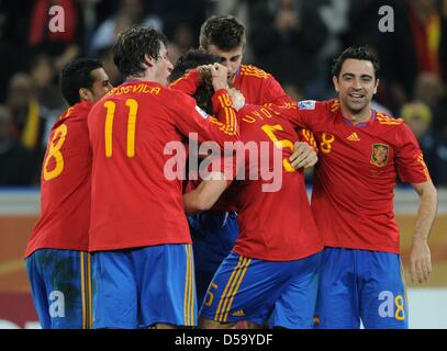 Spanish players celebrate Carles Puyol (5) after he scored the 1-0 during the 2010 FIFA World Cup semi-final match between Germany and Spain at the Durban Stadium in Durban, South Africa 07 July 2010. Photo: Marcus Brandt dpa - Please refer to http://dpaq.de/FIFA-WM2010-TC  +++(c) dpa - Bildfunk+++ Stock Photo