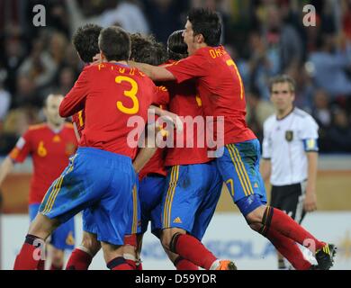 Spanish players Gerard Pique (L) and David Villa (R) celebrate the 1-0 by Carles Puyol (C, hidden) during the 2010 FIFA World Cup semi-final match between Germany and Spain at the Durban Stadium in Durban, South Africa 07 July 2010. Photo: Marcus Brandt dpa - Please refer to http://dpaq.de/FIFA-WM2010-TC  +++(c) dpa - Bildfunk+++ Stock Photo