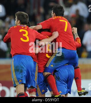 Spanish players Gerard Pique (L) and David Villa (R) celebrate the 1-0 by Carles Puyol (C) during the 2010 FIFA World Cup semi-final match between Germany and Spain at the Durban Stadium in Durban, South Africa 07 July 2010. Photo: Marcus Brandt dpa - Please refer to http://dpaq.de/FIFA-WM2010-TC  +++(c) dpa - Bildfunk+++ Stock Photo