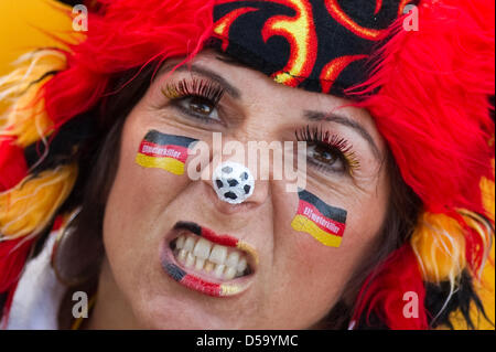 A soccer fans watches the German national team play the semi final at the public screening before on the Elbe Meadows in Dresden, Germany, 7 July 2010. The German national team plays against Spain in the semi final of the FIFA World Cup 2010 in South Africa. Photo: Arno Burgi Stock Photo