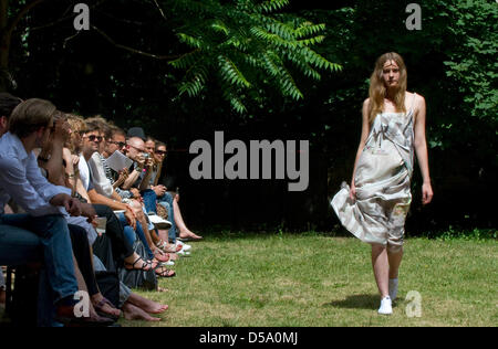 A model walks on a lawn during a show of the label C Neeon at the