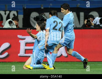 Uruguay's Edinson Cavani celebrates with team mates Martin Caceres (22) and Luis Suarez after equalising 1-1 during the 2010 FIFA World Cup third place match between Uruguay and Germany at the Nelson Mandela Bay Stadium in Port Elizabeth, South Africa 10 July 2010. Photo: Marcus Brandt dpa - Please refer to http://dpaq.de/FIFA-WM2010-TC  +++(c) dpa - Bildfunk+++ Stock Photo