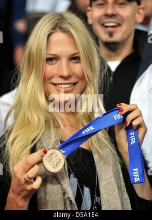 Sarah Brandner, girlfriend of German player Bastian Schweinsteiger, poses in the stands with the bronze medal of Schweinsteiger after the 2010 FIFA World Cup third place match between Uruguay and Germany at the Nelson Mandela Bay Stadium in Port Elizabeth, South Africa 10 July 2010. Photo: Bernd Weissbrod dpa - Please refer to http://dpaq.de/FIFA-WM2010-TC Stock Photo