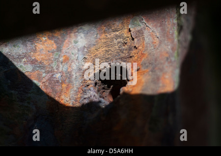 Hole in rusty metal on Shorham Beach, United Kingdom. Stock Photo