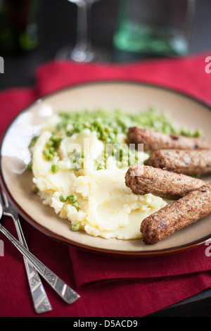 Veggie sausages with mashed potatoes and green peas Stock Photo