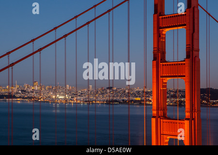 A view at dusk thru the Golden Gate Bridge towards downtown San Francisco. IN California, USA. Stock Photo