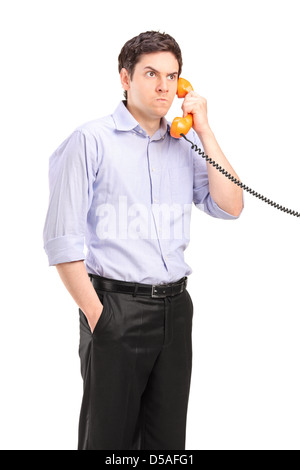 Angry man having a telephone conversation, isolated on white background Stock Photo