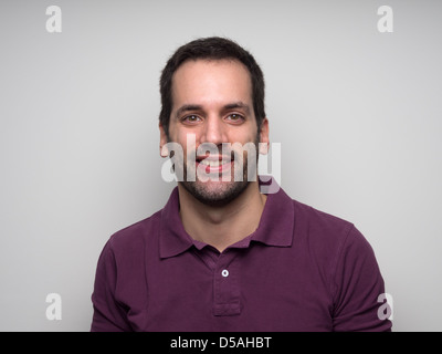 Portrait of a 3-day bearded young man with fake smile Stock Photo