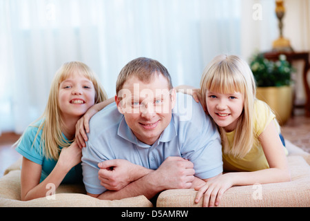 Portrait of a handsome father and his lovely twin daughters Stock Photo