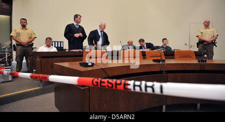 The two defendants Markus S. (2-R) and Sebastian L. (2-L), sit among their defense lawyers prior to the begin of the trial at the Regional Court in Munich, Germany, 13 July 2010. Ten months after the murder of manager Dominik Brunner, the trial of two young men has begun. Sebastian, 17 years at the time of the offence, and Markus, 18 years then, are accused of having beaten Brunner Stock Photo