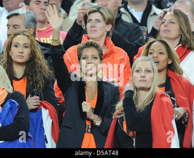 Bouchra van Persie (L-R), wife of Dutch player Robin van Persie, Sylvie van der Vaart, wife of Dutch player Rafael van der Vaart, Andra van Bommel, wife of Dutch player Mark van Bommel and Winonah de Jong, wife of Dutch player Nigel de Jong on the stand prior to the 2010 FIFA World Cup final match between the Netherlands and Spain at Soccer City Stadium in Johannesburg, South Afric Stock Photo