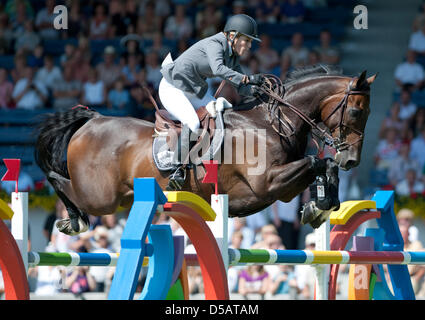 Germany's Meredith Michaels-Beerbaum and her horse 'Chekmate' overcome an obstacle at CHIO in Aachen, Germany, 13 July 2010. Photo: Uwe Anspach Stock Photo