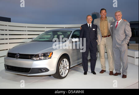 The handout picture dated 19 July 2010 by the Volkswagen Group shows (L-R) Walter de'Silva, chef designer of the Volkswagen Group, actor Ralf Moeller and Martin Winterkorn, chairman of the Board of Management of Volkswagen Group, next to the new model of the VW Jetta, which will be introduced to the US market in San Francisco, USA. Introduction to German and European markets is pla Stock Photo