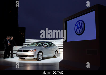 The handout picture dated 19 July 2010 by the Volkswagen Group features two men gazing at the new VW Jetta, which is introduced into the U.S. market.  Introduction to German and European markets is planned for early 2011. Especially in the U.S., the model is a bestseller with 9.6 million sold cars in the world. Up to 110,000 Jettas are sold per year in the U.S. Photo: FRISO GENTSCH Stock Photo