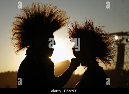 (dpa file) A file picture dated 31 July 2009 of a couple in the backlight during Woodstock Festival in Kostrzyn, Poland. Some 400,000 visitors are expected to the 16th edition of Kostrzyn's Woodstock Festival taking place the upcoming weekend until 02 August 2010. With respect to the recent Love Parade tragedy in Duisburg the security concept for the festival is revised. Photo: Han Stock Photo