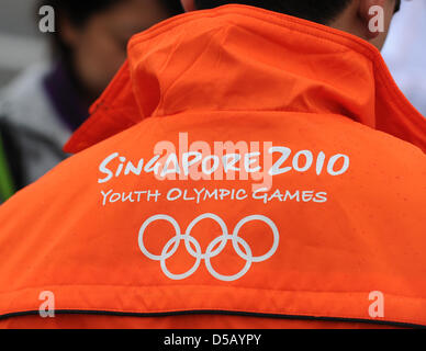 A man wears a jacket showing the logo of the Youth Olympic Games in Singapore at the Youth Olympic Day in Berlin, Germany, 24 July 2010. The Youth Olympic Games travel across five continents with Berlin being the first leg. The Youth Olympic Games will take place for the first time in Singapore from 14 August until 26 August 2010. Photo: Jens Kalaene Stock Photo