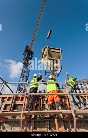 Construction site workers concrete pouring Stock Photo