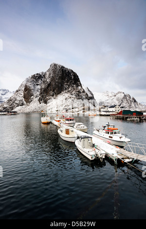 A view of boats tied up in the pretty fishing harbour at Hamnoy, with Lilandstinden in the background Stock Photo