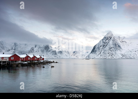 A view Reinefjorden towards the mountain of Olstind from the pier at Hamnoy harbour on the Lofoten islands, Norway