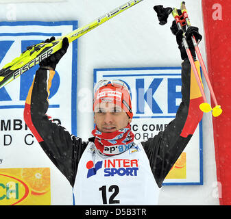 German Bjoern Kircheisen cheers on the podium after the 10km cross country skiing competition of the nordic combined world cup event in Oberhof, Germany, 03 January 2010. Kircheisen finished third. Photo: HENDRIK SCHMIDT Stock Photo