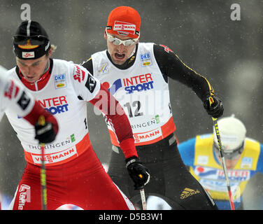 Austrian Felix Gottwald (L) and German Bjoern Kircheisen shown in action during the 10km cross country skiing competition of the nordic combined world cup event in Oberhof, Germany, 03 January 2010. Kircheisen finished third behind Gottwald. Photo: HENDRIK SCHMIDT Stock Photo