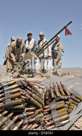 Afghan Border Policemen with 3rd Kandak deploy a heavy machine gun while setting up a new checkpoint in the district March 25, 2013 in Spin Boldak, Kandahar province, Afghanistan. Stock Photo