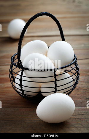 Whitel easter eggs in black wire basket Stock Photo