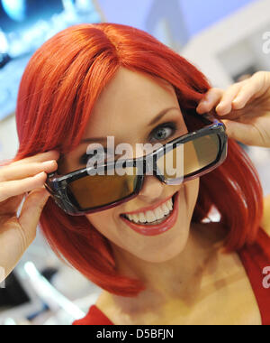 'Miss IFA' poses with her 3D glases on the fairground in  Berlin, Germany, 1 September 2010. Organizers of the fair promise more new products than ever before  for the 50th edition of the IFA that takes place between 3-8 September 2010. According to the fair, more than 1420 exhibitors offering electronic goods for home use and entertainment are gathered on a 134.400sqm large exhibi Stock Photo