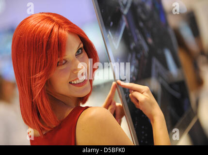 'Miss IFA' poses with a flat-screen at the booth of Samsung on the IFA fairground in  Berlin, Germany, 1 September 2010. Organizers of the fair promise more new products than ever before  for the 50th edition of the IFA that takes place between 3-8 September 2010. According to the fair, more than 1420 exhibitors offering electronic goods for home use and entertainment are gathered  Stock Photo