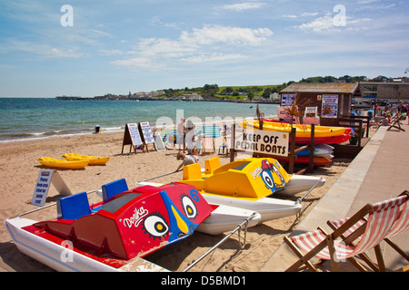 Colourful pedal-boats on Swanage beach in Dorset England UK Stock Photo