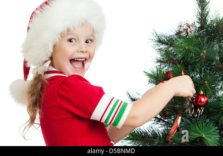 pretty preschool child decorating Christmas tree isolated on white Stock Photo