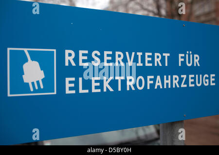 A sign marked with 'Reserved for Electric vehicles' stands on a parking lot in Berlin, Germany, dated 13 December 2009. Photo: Arno Burgi Stock Photo