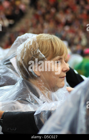 Angela Merkel Norbert Lammert celebrating the Mass of Pope Benedict XVI at olympic stadium wearing rain coats. Berlin, Germany Stock Photo