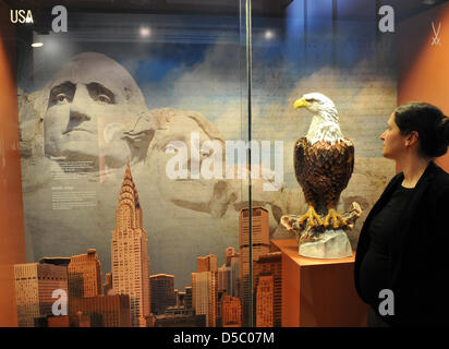 A staff member of Meissen Porcelain Manufactory eyes a sculpture of US heraldic animal, a bald eagle, that is part of the exhibition celebrating the 300th anniversary of Meissen Porcelain in Meissen, Germany, 20 January 2010. The exhibition 'All Nations Are Welcome' is the company's largest special exhibition and will open on 23 January 2010. In 2008, the manufactory with the 'cros Stock Photo