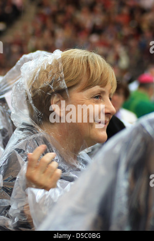 Angela Merkel rbert Lammert celebrating the Mass of Pope Benedict XVI at olympic stadium wearing rain coats. Berlin Germany Stock Photo