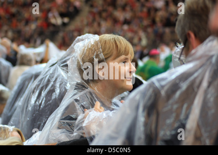 Angela Merkel Norbert Lammert celebrating the Mass of Pope Benedict XVI olympic stadium wearing rain coats. Berlin, Germany - Stock Photo