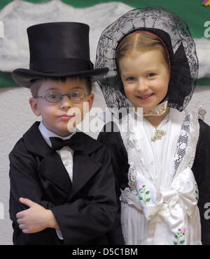 Boys and girls celebrate the Sorbian custom 'Praci Kwas', the 'Birds' Wedding', at the kindergarten in Crostwitz near Bautzen, Germany, 25 January 2010. They wear traditional costumes and sing the song 'The Birds' Wedding' in Sorbian. Every year in the night of 25 January, children put a plate on the windowsill which will be filled with pastries and sweets in the morning - the bird Stock Photo