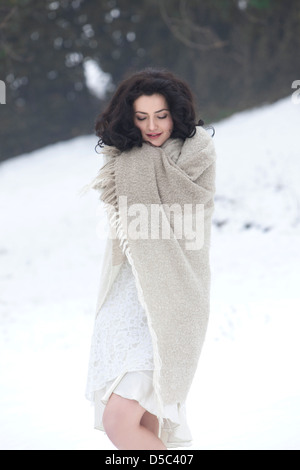 woman shivering with a blanket in the country Stock Photo