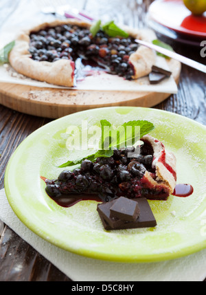 piece of berry pie on the background of the whole pie, closeup Stock Photo