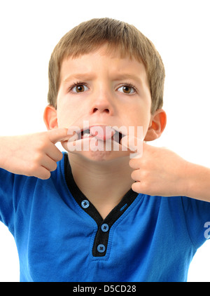 Little boy sticking out tongue with funny face Stock Photo - Alamy