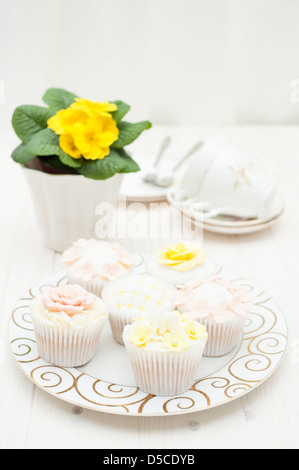 Mixed cupcakes in a pastel, shabby chic style with sugarcraft decorations Stock Photo